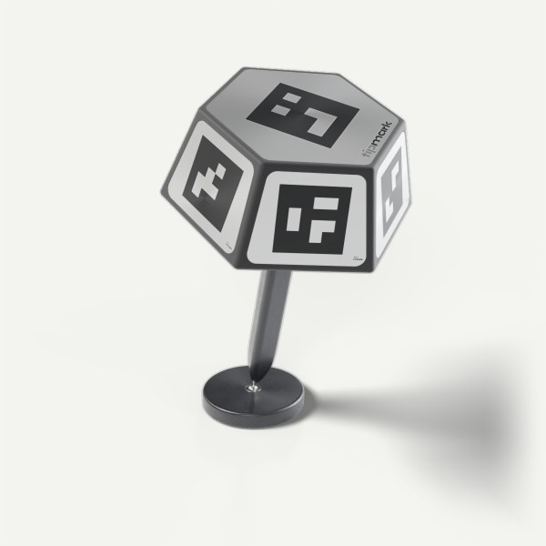 PEN-10 seated in its pivot calibration stand: a round black anodised aluminium block with a hardened steel seat